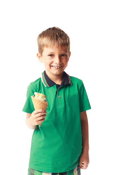 istock Little boy eating ice cream isolated on white 528344267