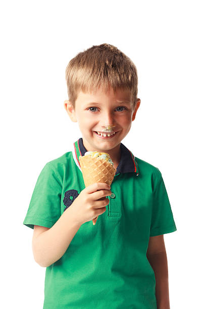 istock Little boy eating ice cream isolated on white 528344277