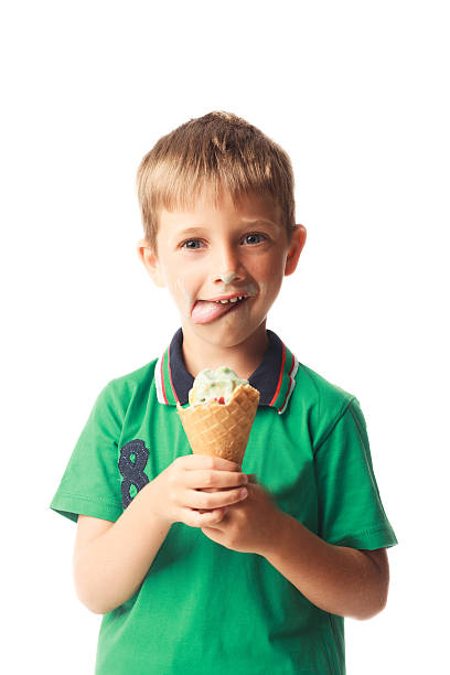 istock Little boy eating ice cream isolated on white 528344285