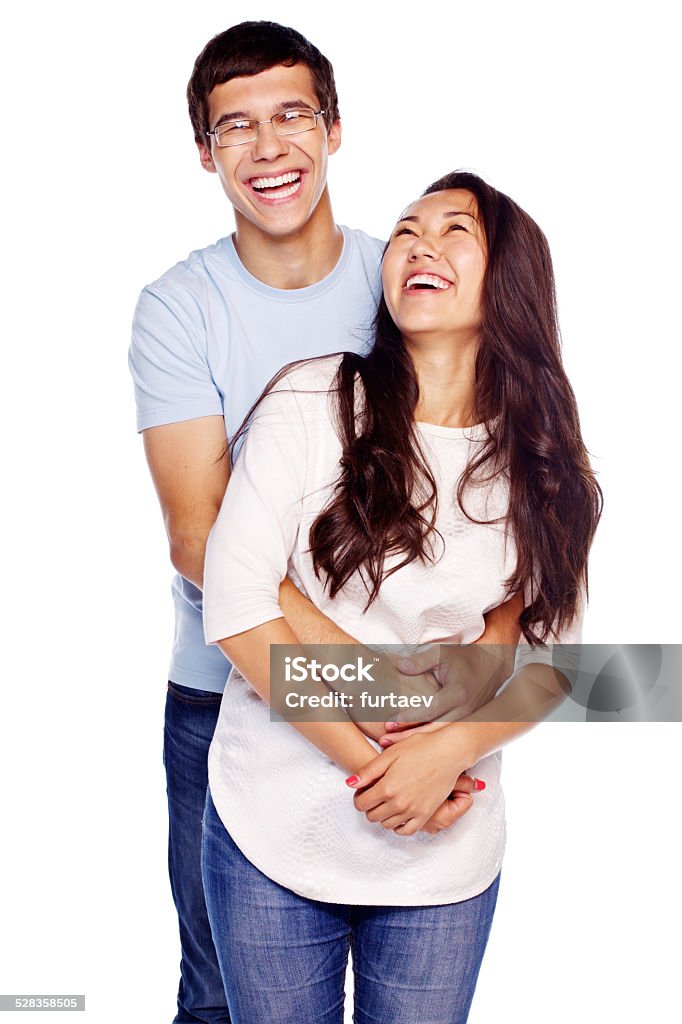 Laughing couple hugging Portrait of young embracing couple isolated on white background Cut Out Stock Photo