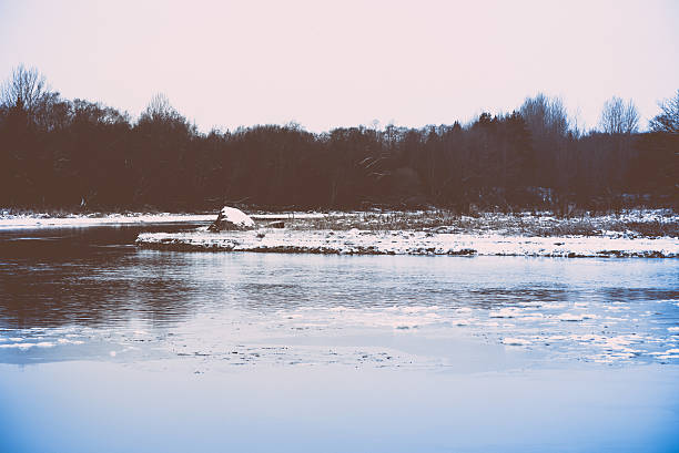 istock cold winter landscape with frozen river. retro vintage polaroid 528358727