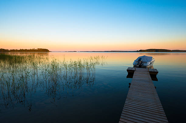 istock Boat in Sunset on Calm Lake in Finland 528360865