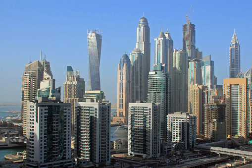 Aerial view of the modern buildings in Dubai Marina depicting growth, wealth and travel destinations