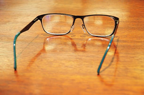 istock Pair of glasses on the wooden table 528363861