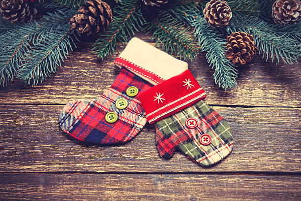 istock Mitten and sock on table near pinecones and branches 528364847