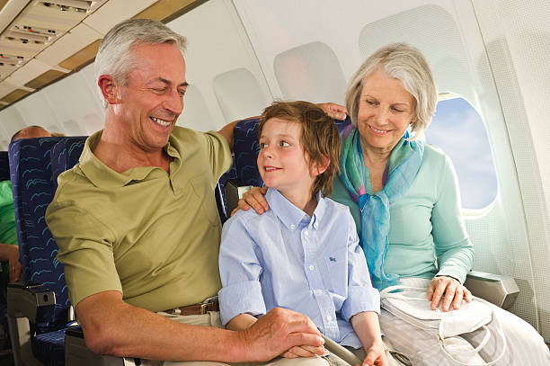 istock Boy and senior people smiling  on airplane 528371737