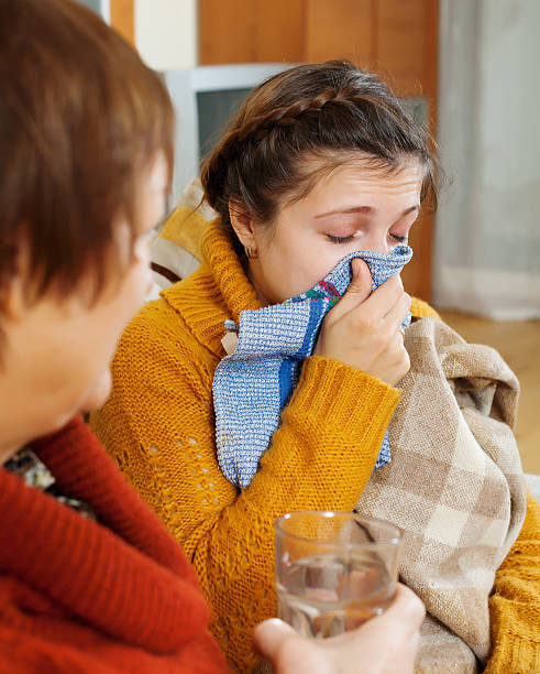 istock woman with blow nose uses handkerchief 528371873