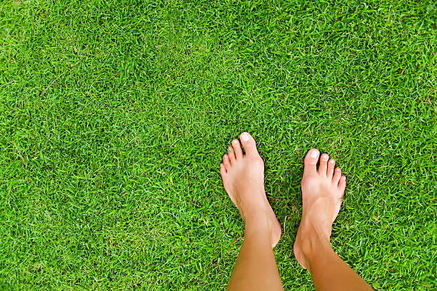 Female feet on the grass Bali barefoot stock pictures, royalty-free photos & images