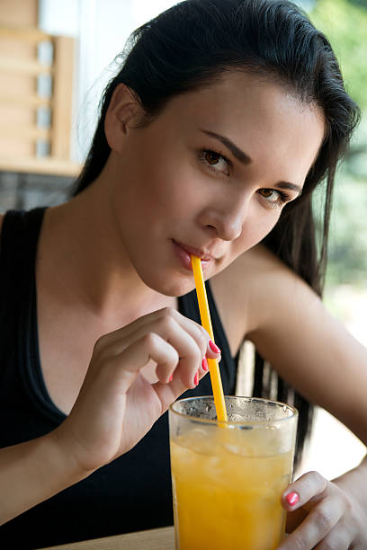 istock Young European  woman drinking lemonade  in an cafe 528376509