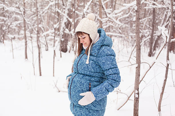 istock Pregnant woman in winter forest 528377233