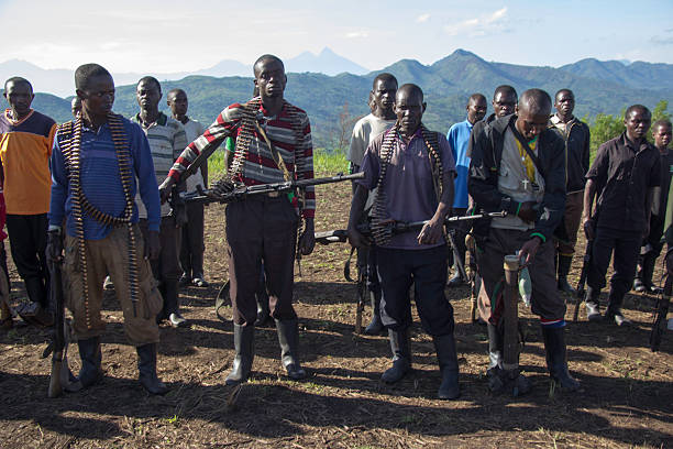 Heavily Armed Soldiers Chai, North Kivu, DRC - March 29, 2014: FDLR soldiers receiving orders on a football field before going on patrols. guerrilla warfare photos stock pictures, royalty-free photos & images