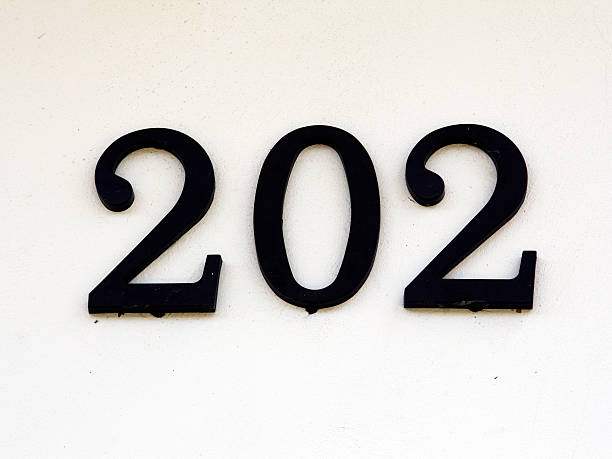 istock house number two hundred and two on a white wall 528392131