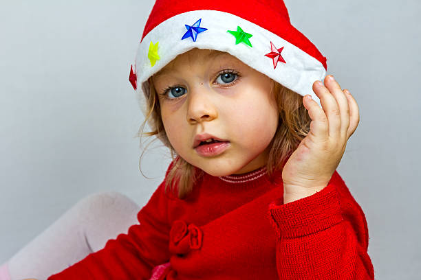 istock Happy small girl in Santa hat 528393599
