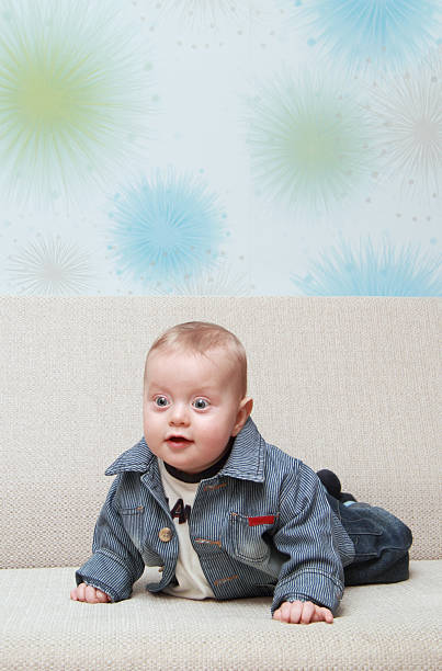 istock baby try to creep on couch 528394345