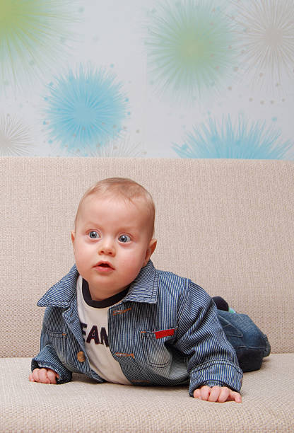 istock baby try to creep on couch 528394347