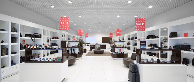 bright and fashionable interior of shoe store in modern mall