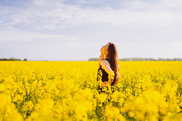 istock Girl touches her neck on rapeseed meadow 528410811