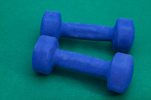 istock Couple of blue dumbbells on green 528411367