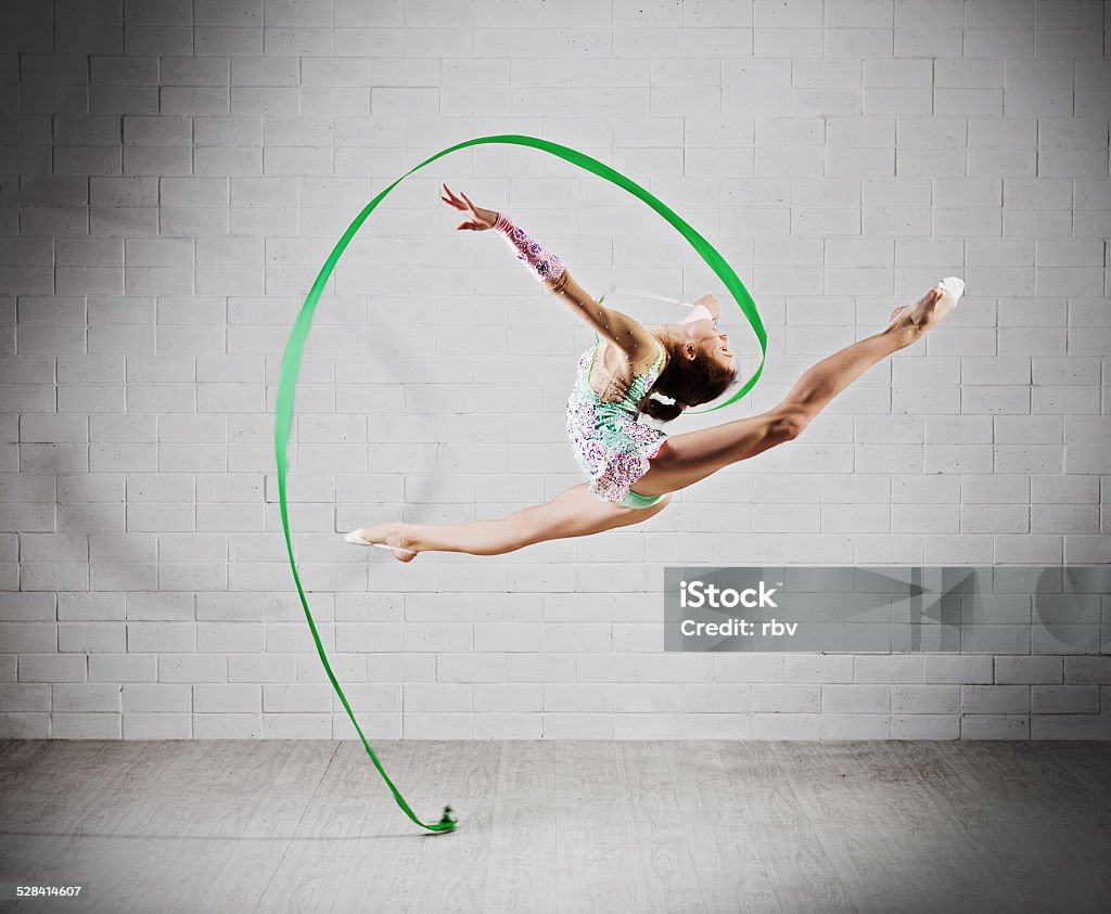 Girl is engaged in art gymnastics Young girl is engaged in art gymnastics Activity Stock Photo