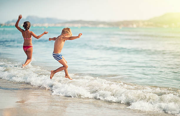 istock Kids having fun in sea 528414627