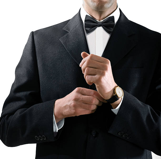 istock man in tuxedo puts on watch 528414791