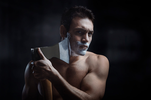 Man shaves using an axe