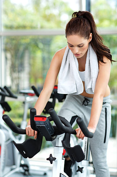 istock woman biking indoors 528415007