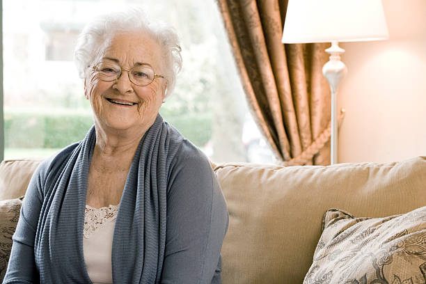 istock Woman Sitting on Couch in Nursing Home 528415175