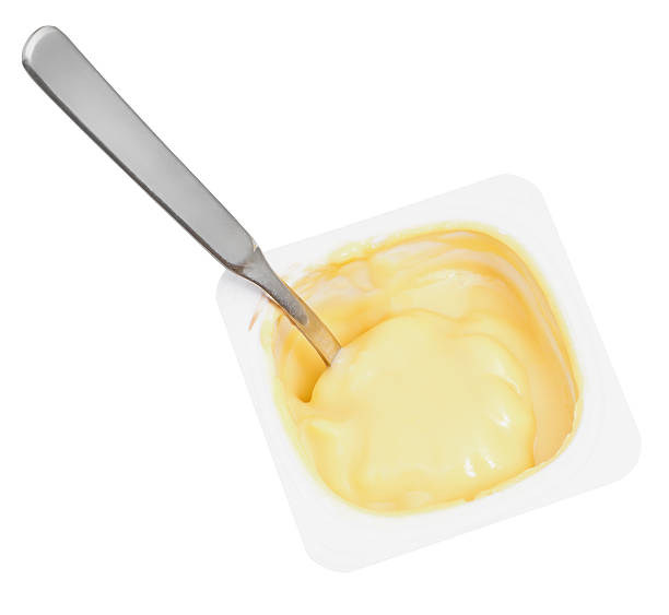 istock caramel yogurt and spoon in disposable cup 528415317