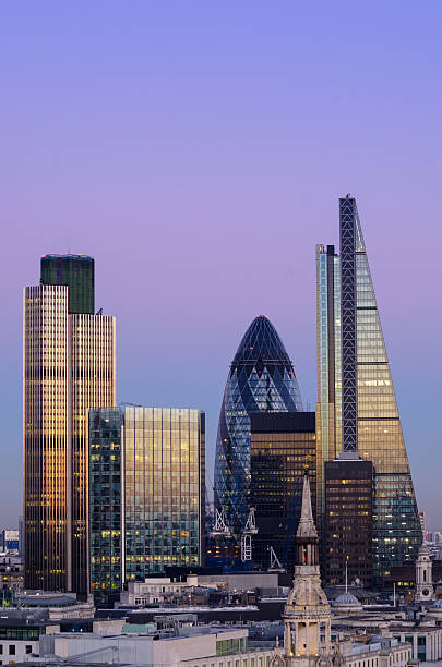 City of London skyscrapers at Dusk Elevated view of The City of London at dusk. The City is London's traditional financial and global business district. The distinctive 'Gherkin' skyscraper, Tower 42 and the recently completed 122 Leadenhall Street feature on the constantly changing skyline. gherkin london night stock pictures, royalty-free photos & images