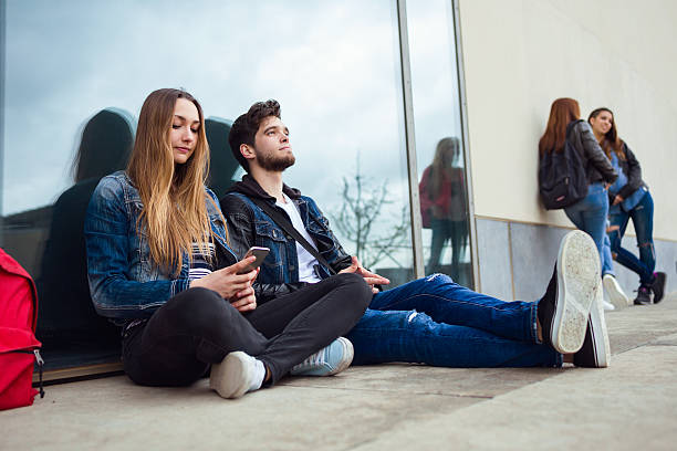 istock Group of students having fun with smartphones after class. 528416352