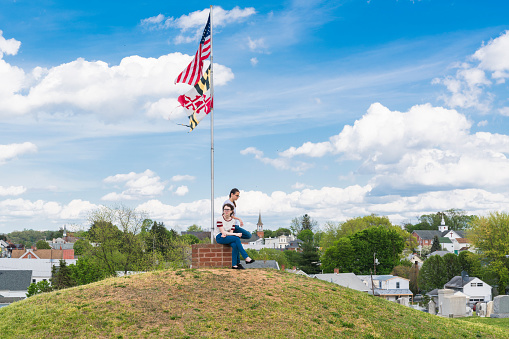 Doubleday Hill - Civil War's national monument, Williamsport, Maryland, USA. Two girls at the top of the hill, under the American and Maryland Flags.