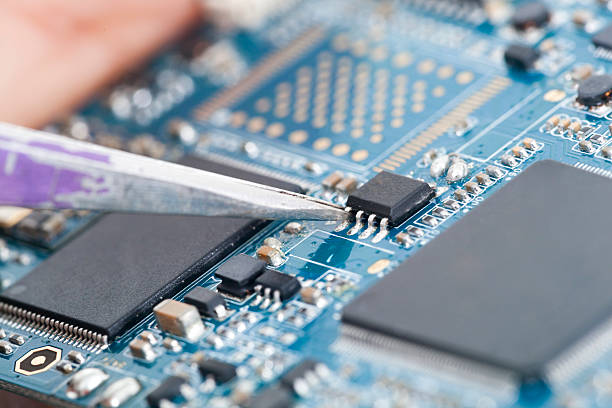 istock Technician holding chip in tweezers 528417456