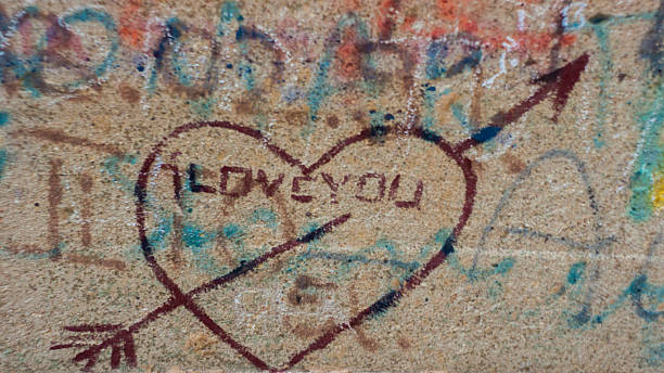 istock Graffiti Cupid arrowed heart symbol on a wall. 528417545