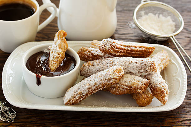 istock Churros with hot chocolate and powdered sugar. 528417866