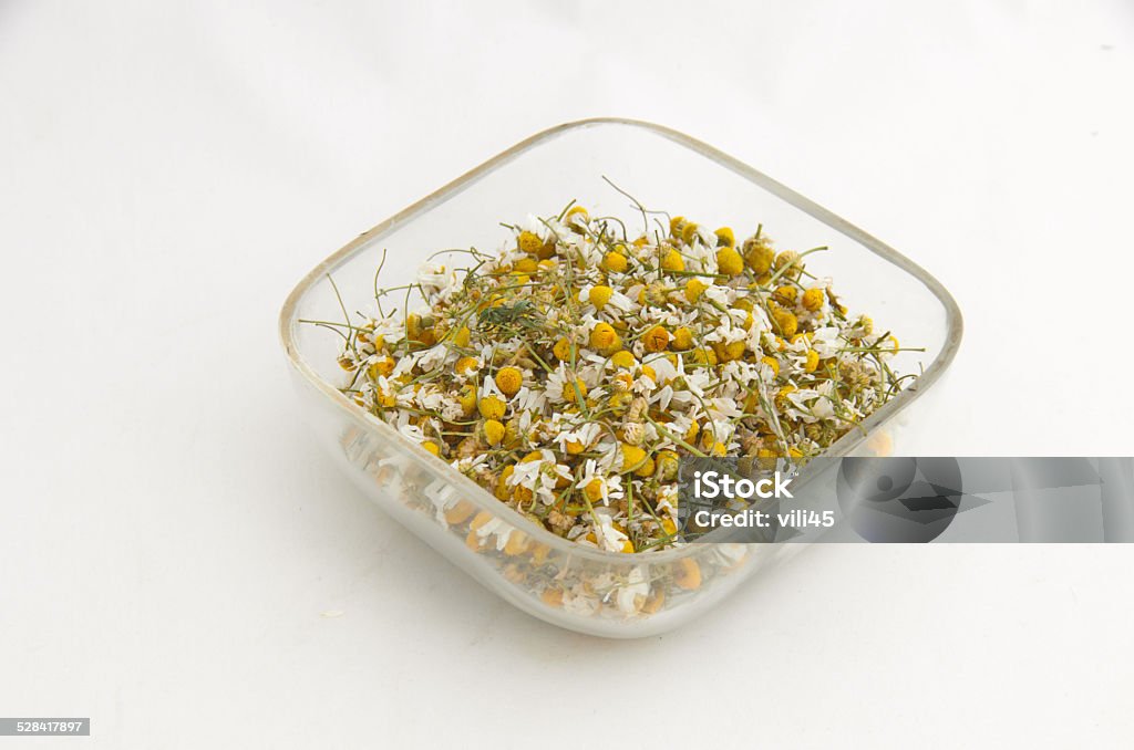 Ecological medicative dry herb flower - camomile Ecological medicative dry herb flower - camomile  on the glass plate Blade of Grass Stock Photo