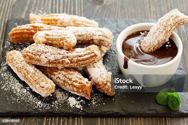 Churros With Hot Chocolate And Powdered Sugar Stock Photo - Download Image Now - Churro, Spain, Spanish Culture