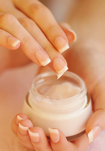 istock Beautiful woman hands with cream 528421656