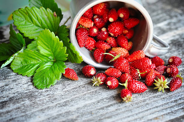 Fresh wild strawberries on an old wooden table