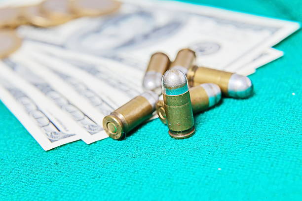 A fragment of the American dollar can be seen on the table and weapons.