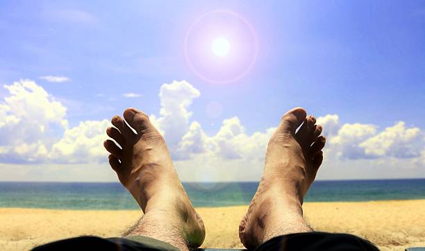 istock Foot on the beach with bright sunlight 528423978