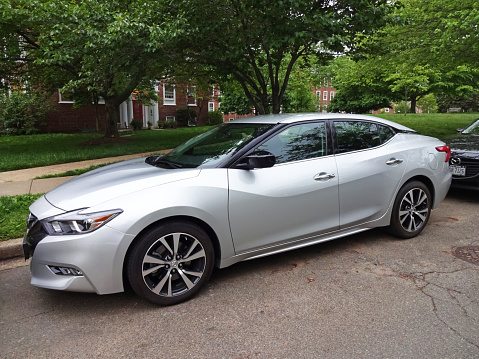 Washington DC, USA-May 5, 2016:  This silver Nissan Maxima sport sedan was spotted in a quiet Northwest Washington DC neighborhood.  Price starts at $32510 for the basic model with a 300 hp V6 engine.  Performance is good with fuel economy of 22 mpg city and 30 mpg highway.