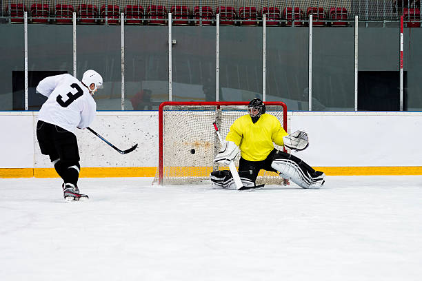 istock Ice Hockey Player Shooting at Goal 528424633