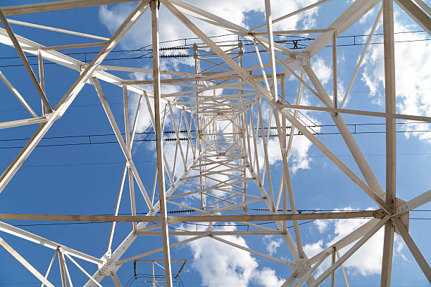 istock Bottom view power transmission lines against blue sky 528424923