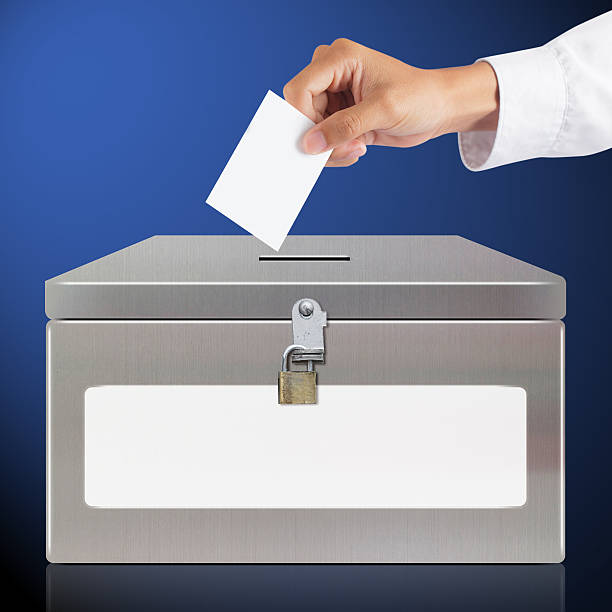 istock Hand with ballot and metal box 528426621
