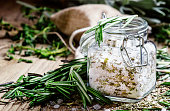 Sea salt with dried rosemary in a glass jar