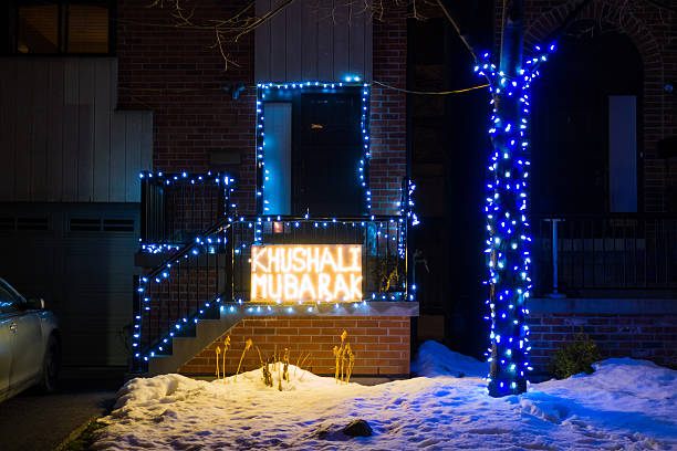 Khushali Mubarak Toronto, Canada - December 14, 2014: House and front yard decorated with colorful lights and with the words Khushali Mubarak. Khushali Mubarak is the celebration of the birthday of Prince Karim Aga Khan, the spiritual leader of the Shia Imami Ismaili Muslims. aga khan iv stock pictures, royalty-free photos & images