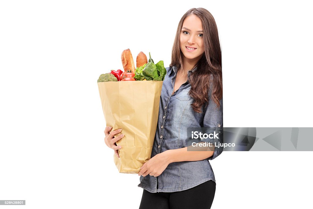 Young girl holding a grocery bag Young girl holding a grocery bag isolated on white background 20-29 Years Stock Photo