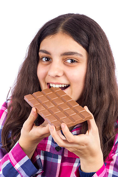 istock girl eating chocolate 528428827