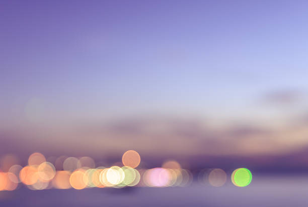 istock Blurred view of city bokeh with pink sky background 528429562